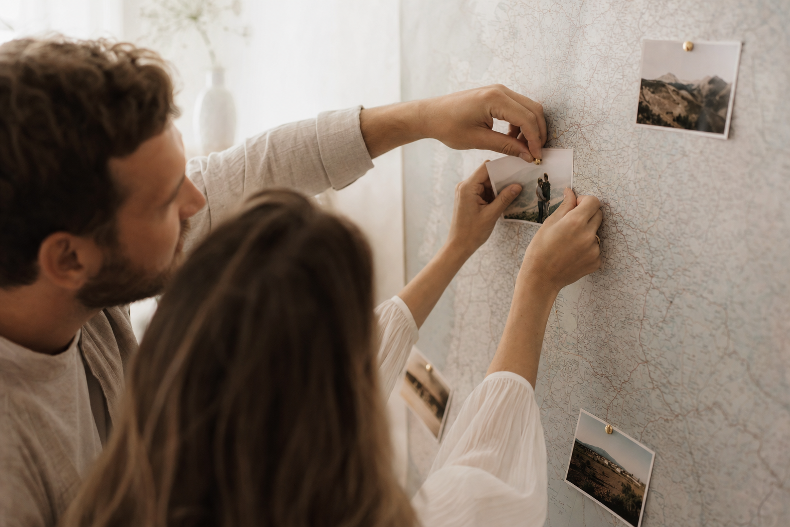 Couple pinning a photo on a map as they map places visited together